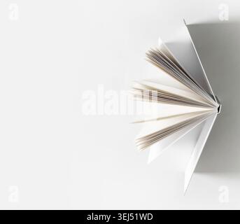 Open book on white paper background. Space for text Stock Photo