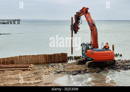 Heavy pile driving machine installing concrete foundation piles at an ...