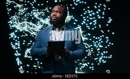 Optimizing neural network, tablet and computer scientist using AR simulation neurons map. Fine tuning AI model, device and African american man adjusting machine learning synaptic weights, camera A Stock Photo