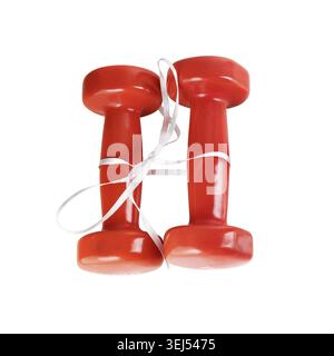 Two red dumbbell. Red dumbbells tied with satin ribbon. Isolated with clipping path on white background. Top view Stock Photo