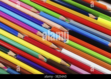 Bright color pencils lying on a flat surface. Colored pencils as background Stock Photo