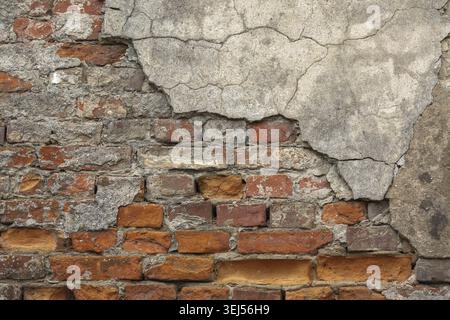 Texture of old brick wall with chipped plaster Stock Photo