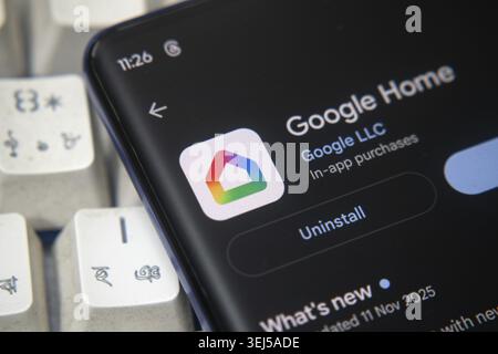 Dhaka, Bangladesh 26 Dec 2025:The screen of a mobile device shows the Google Home application with the Google logo as a background, showcasing smart h Stock Photo