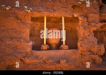 Sandstone Carving of Face and Hands Behind Bars in Mesquite Nevada Cliff Stock Photo