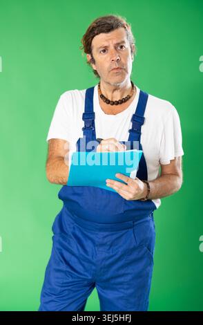 employee holds a folder with documents in hands against the background of chromakey Stock Photo