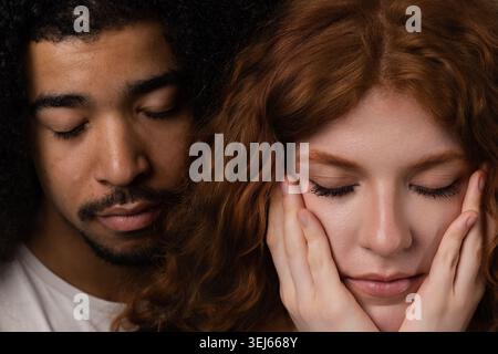 Couple expressing closeness and emotion with eyes closed, having an intimate connection Stock Photo