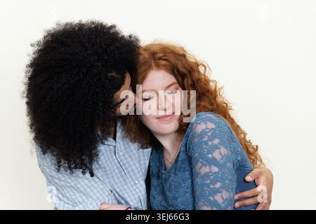 Diverse young couple showing love and closeness with a gentle hug Stock Photo