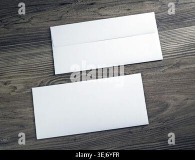 Two white blank envelopes on wooden background. Front and back side Stock Photo