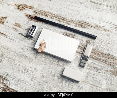 Photo of blank stationery on vintage wooden table background. Business cards, pencil, eraser, flash drive and sharpener Stock Photo
