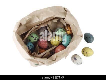 Colored quail eggs in a package of brown paper on white background. Isolated with clipping path. Top view Stock Photo