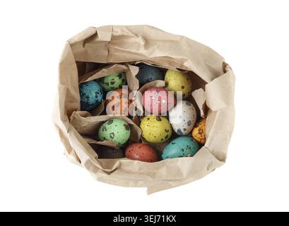 Colored quail eggs in a paper bag on a white background. Isolated with clipping path Top view Stock Photo