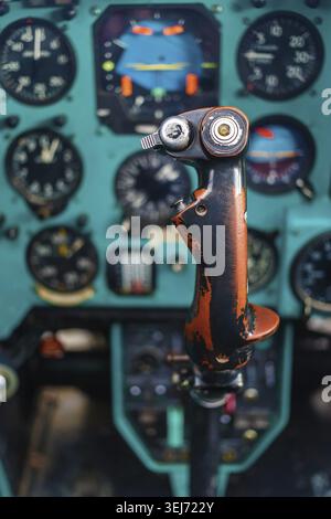 Frontal view of the control stick in the cockpit of large retro passenger helicopter. Shallow depth of field. Selective focus on stick Stock Photo