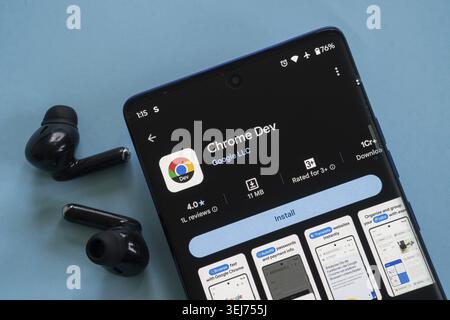 Dhaka, Bangladesh 23 August 2025:A smartphone displaying the Chrome Dev app in the app store with black earphones Stock Photo