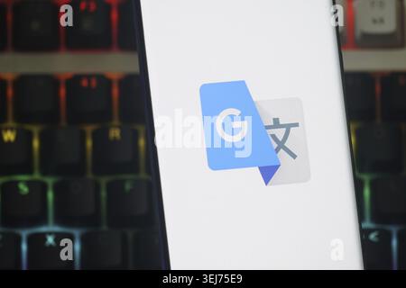 Dhaka, Bangladesh 23 August 2025:Google Translate app icon on a smartphone screen with a backdrop of colorful keyboard keys Stock Photo