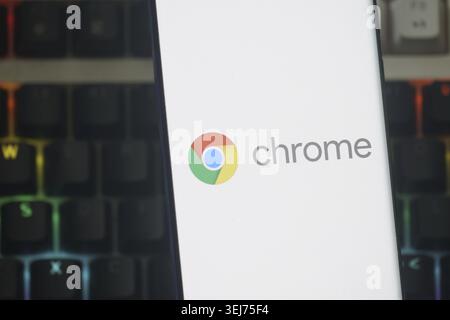 Dhaka, Bangladesh 23 August 2025:Google Chrome logo displayed on a smartphone screen with a lit keyboard background Stock Photo