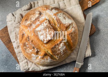 Homemade Whole Wheat Sourdough Bread Loaf on a Cutting Board Stock Photo