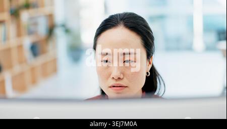 Confused, business and Asian woman on computer in office for feedback, project and online report. Thinking, professional and person on pc with doubt Stock Photo