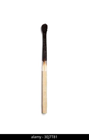 Burnt matchstick rests on a plain white background after being used Stock Photo
