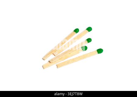Several matchsticks with green tips on a white background placed flat Stock Photo
