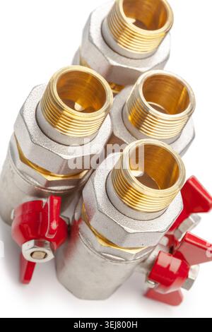 Four metal valves with red handles on a white background Stock Photo