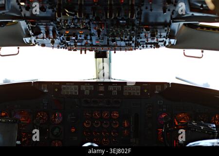 Cockpit interior of a historic presidential aircraft with overhead controls, gauges, and pilot instruments on display. Stock Photo