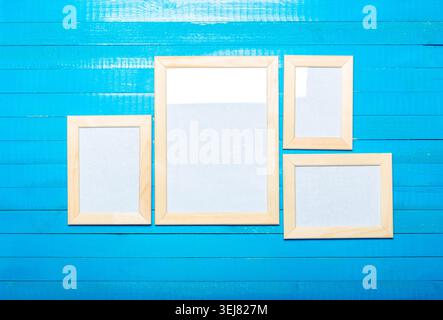 Empty frames placed on a blue wooden background for decoration or art display Stock Photo