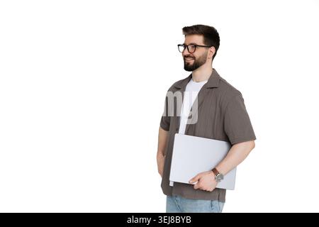 Young man holding laptop while walk on white background Stock Photo