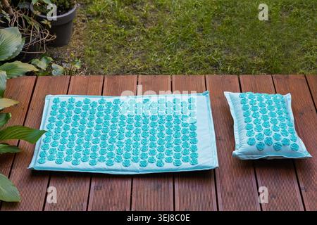 Blue Acupressure Mat Set on Garden Terrace Stock Photo