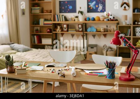 Child Bedroom Study Space with School Supplies and Space Themed Decor Stock Photo
