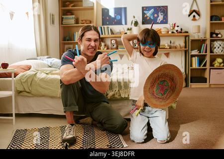 Father and Son Playing Superhero Game for Family Bonding Stock Photo