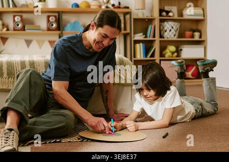Father and Child Drawing Together at Home for Family Bonding Stock Photo
