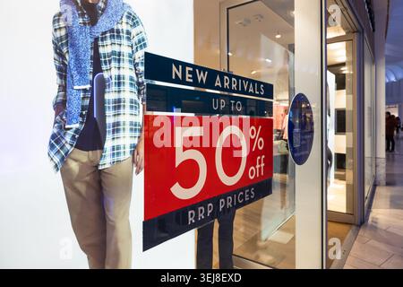 Red sale sign with fifty percent discount in a clothing store window. London, UK, 17 February 2024 Stock Photo