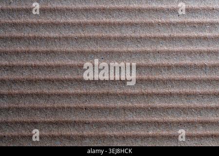 Brown corrugated cardboard texture background, close up. Macro shot of brown corrugated cardboard with vertical ridges. Recycled paper texture for pac Stock Photo