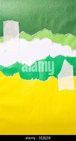 Torn pieces of green paper contrasting with an yellow background, attached with adhesive strips, creating an abstract design, modern creative mockup Stock Photo