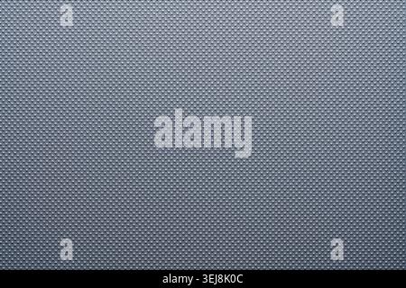 Close up of dark grey synthetic material with a small embossed dotted texture. Clean abstract background for industrial automotive and tech product de Stock Photo
