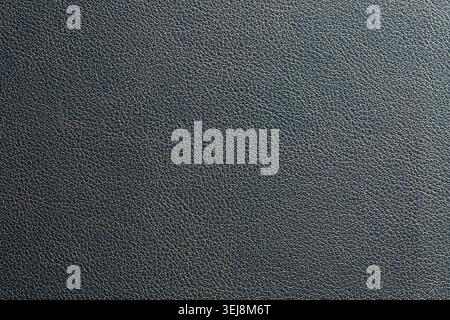 Dark gray faux leather texture background with soft light gradient. Close up of dark gray leather texture background with fine grain pattern and elega Stock Photo