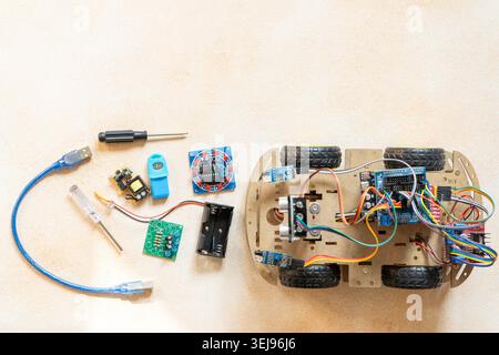 DIY Robot Car Assembly and Components top view. Educational electronics project for STEM learning and robotics. Stock Photo