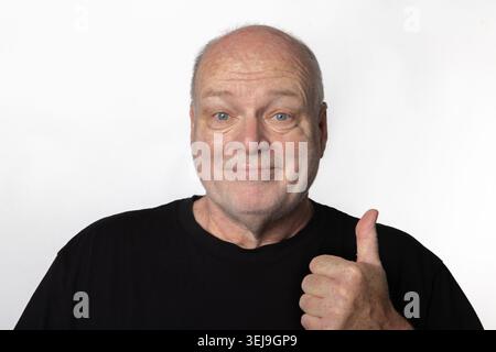 Happy 60 Year Old Man Giving Thumbs Up Isolated on White Background Stock Photo