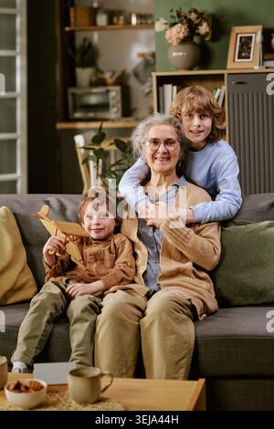 Portrait of Senior Woman Bonding with Grandsons at Home Stock Photo