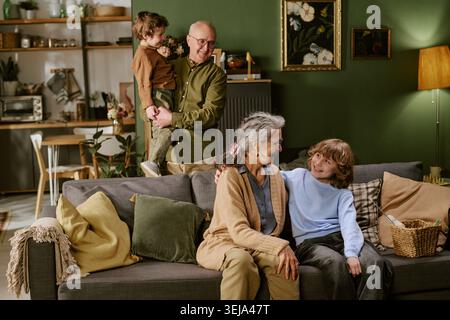 Senior Couple with Grandchildren Spending Time at Home Stock Photo