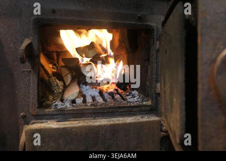 Log fire in cozy log cabin Stock Photo
