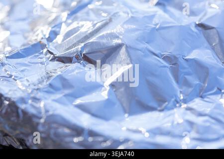 Shininess and reflections on a textured silver aluminum foil background Stock Photo