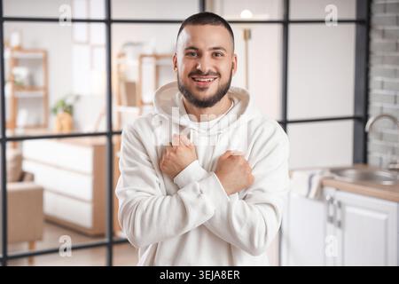 Young man using sign language in kitchen Stock Photo