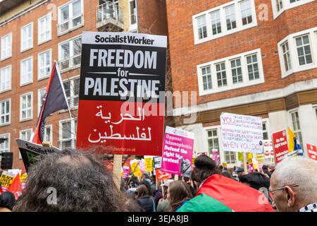 Protesters hold freedom for Palestine sign at a street rally. London, UK, 16 March 2024 Stock Photo