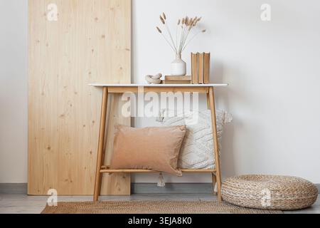 Wooden bench, pouf and folding screen in interior of room Stock Photo