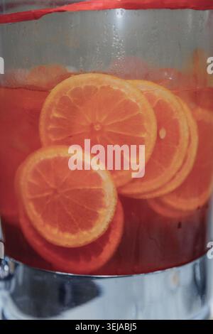 Vibrant orange slices float in rich red liquid Stock Photo