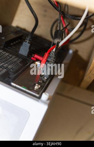 Messy Computer Cables and Internet Network Wires Connected to PC Back Panel Stock Photo