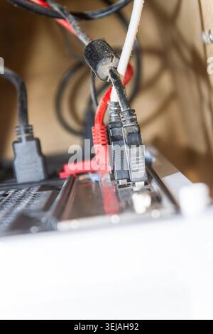 Close-Up of Dusty Network and USB Cables Connected to Computer Back Panel Stock Photo