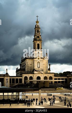 The iconic Basilica of Our Lady of the Rosary rises dramatically beneath dark storm clouds. Stock Photo