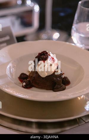 Chocolate dessert with ice cream served on elegant restaurant table Stock Photo